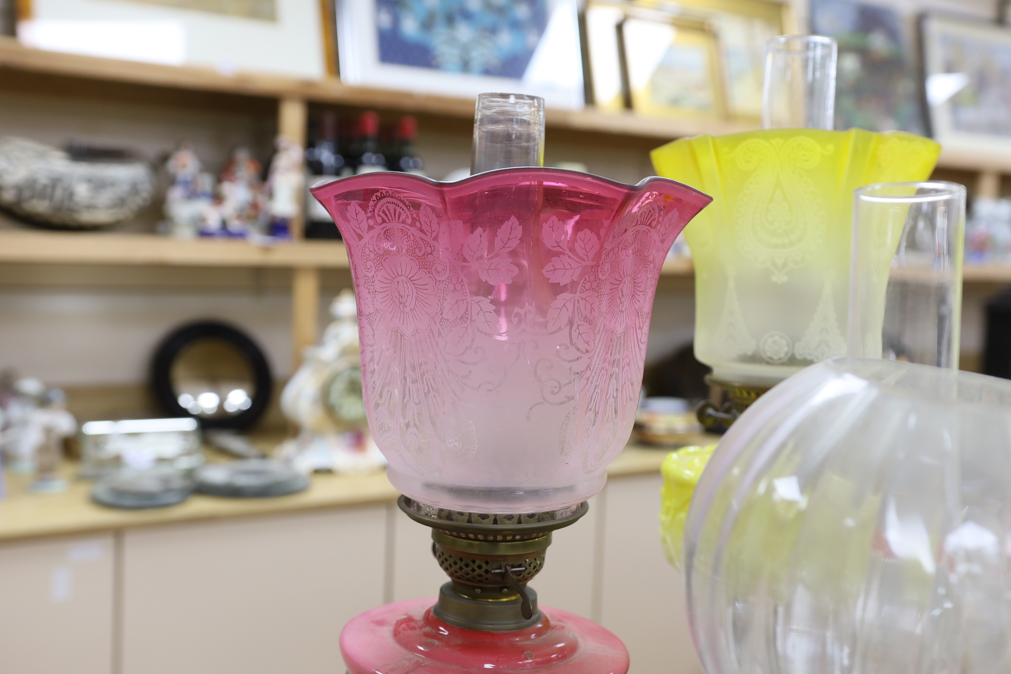 Four Victorian/Edwardian oil lamps with glass shades, tallest 69cm